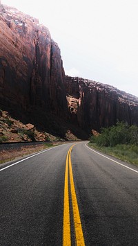 Road mobile wallpaper background, scenic route leading to a mountain
