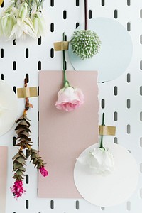 Blank card on the wall surrounded by flowers