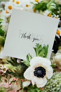Bouquet of white flowers with a blank card
