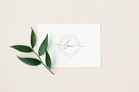 Ruscus leaves with a white invitation card mockup