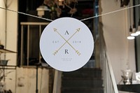 White round paper mockup hanging on a thread in a shop