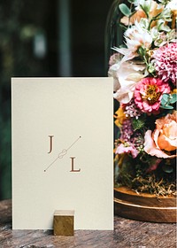 Card mockup by bouquet of flowers on a wooden table