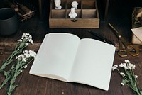 Blank notebook mockup on an artists desk