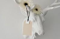 Tag mockup on a deer head decorated with flowers