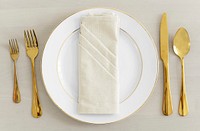 Gold cutlery table setting flatlay