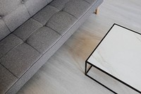 Gray sofa bed by a marble table