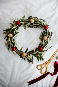 Handmade Christmas wreath decoration on a white fabric background