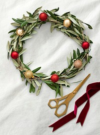 Handmade Christmas wreath decoration on a white fabric background