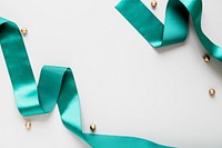 Green silky ribbon on a gray background