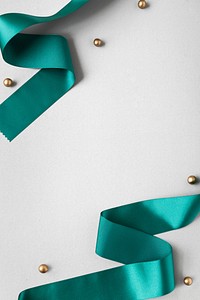 Green silky ribbon on a gray background
