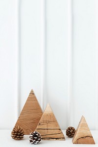 Triangular wooden Christmas ornament on a table