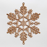 A gold snowflake Christmas ornament isolated on gray background