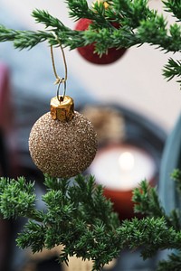 Festive shimmering bauble on a Christmas tree