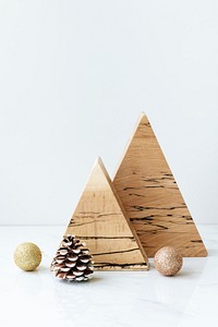 Triangular wooden Christmas ornament on a table