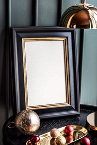 Photo frame surrounded by Christmas ornaments