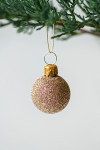 A glitter gold ball Christmas ornament