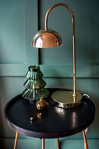 Rose gold shiny lamp on a table with Christmas ornaments