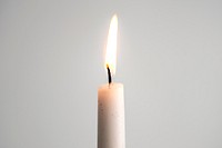 A white pillar candle burning for Christmas day