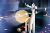 White reindeer surrounded by festive baubles