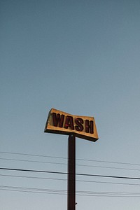 Old rustic car wash sign in the blue sky