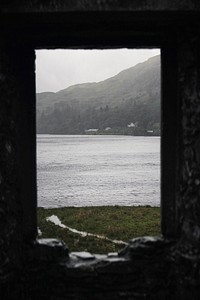 Sea view through a rocky window of Kilchurn Castle, Scotland