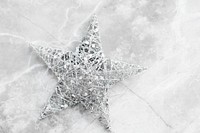 Silver wire Christmas star on marble background