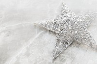 Silver wire Christmas star on marble background