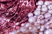 Glitter pink baubles and sequin textile background