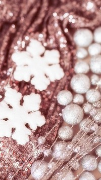 White snowflake ornament on pink sequin background