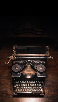 Old typewriter on a wooden table mobile phone wallpaper