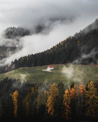 House in solitude amongst the fog near the Dolomites 