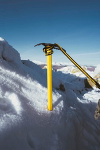 Yellow ice axe in the snow