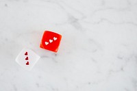Two heart dices on a white marble background