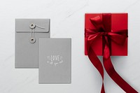 Red present by gray envelopes mockup