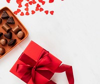 Chocolates by a box of red present 