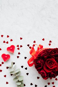 Box of red roses and heart decorations