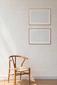 Blank picture frames hanging above a classic wooden chair