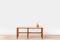 Brown pear on a wooden bench in a white room