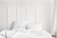 White bed linen in a bed in a bedroom