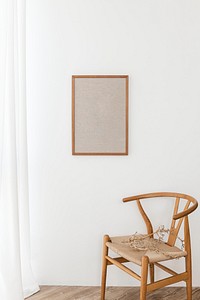 Blank picture frame hanging above a classic wooden 