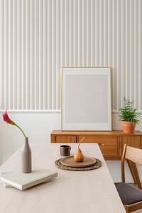 Blank frame on a wooden sideboard in a dining room