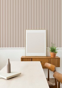 Blank large frame on a wooden sideboard in a living room