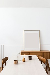 Blank large frame on a wooden sideboard in a living room