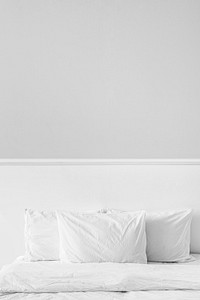 White bed linen in a bed in a bedroom