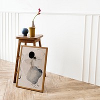 Picture frame mockup by a wooden stool