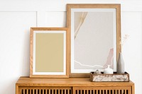 Picture frame mockups on a wooden sideboard table