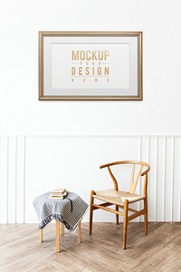 Picture frame mockup hanging above a classic wooden chair