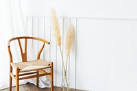 Classic wooden chair by a vase of dry pampas grass