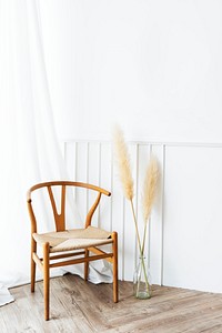 Classic wooden chair by a vase of dry pampas grass