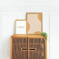Picture frame mockups on a wooden cabinet